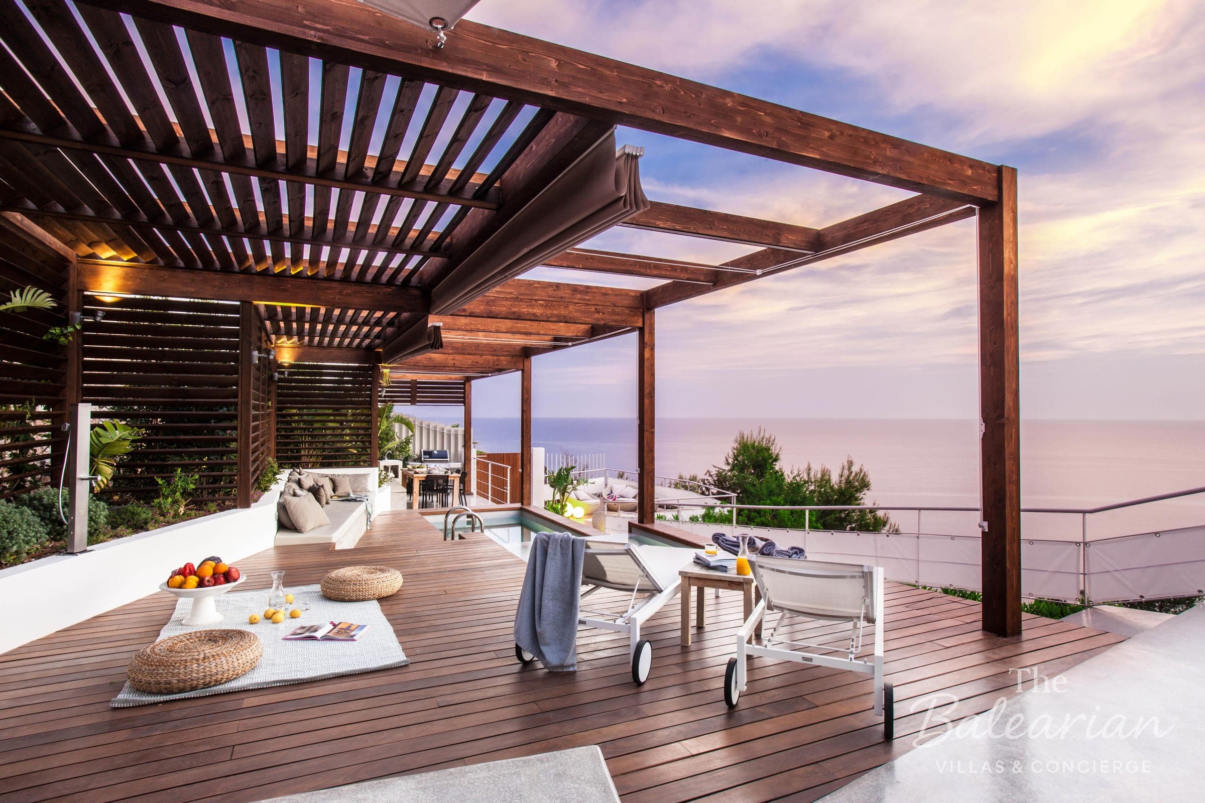 Terrace with pergola and sea view at sunset in Ibiza
